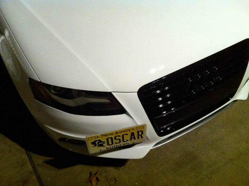 Tow hitch mounted license plate bracket